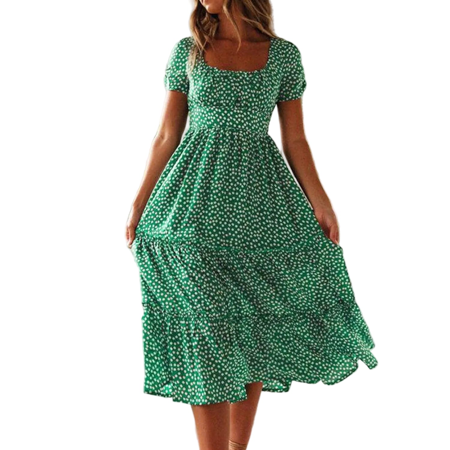 Woman wearing a green floral dress in a bright room with large windows.